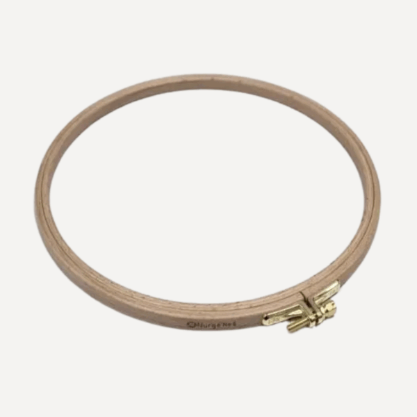 Wooden embroidery hoop with brass screw for cross-stitch and embroidery projects, high-quality crafting tool.