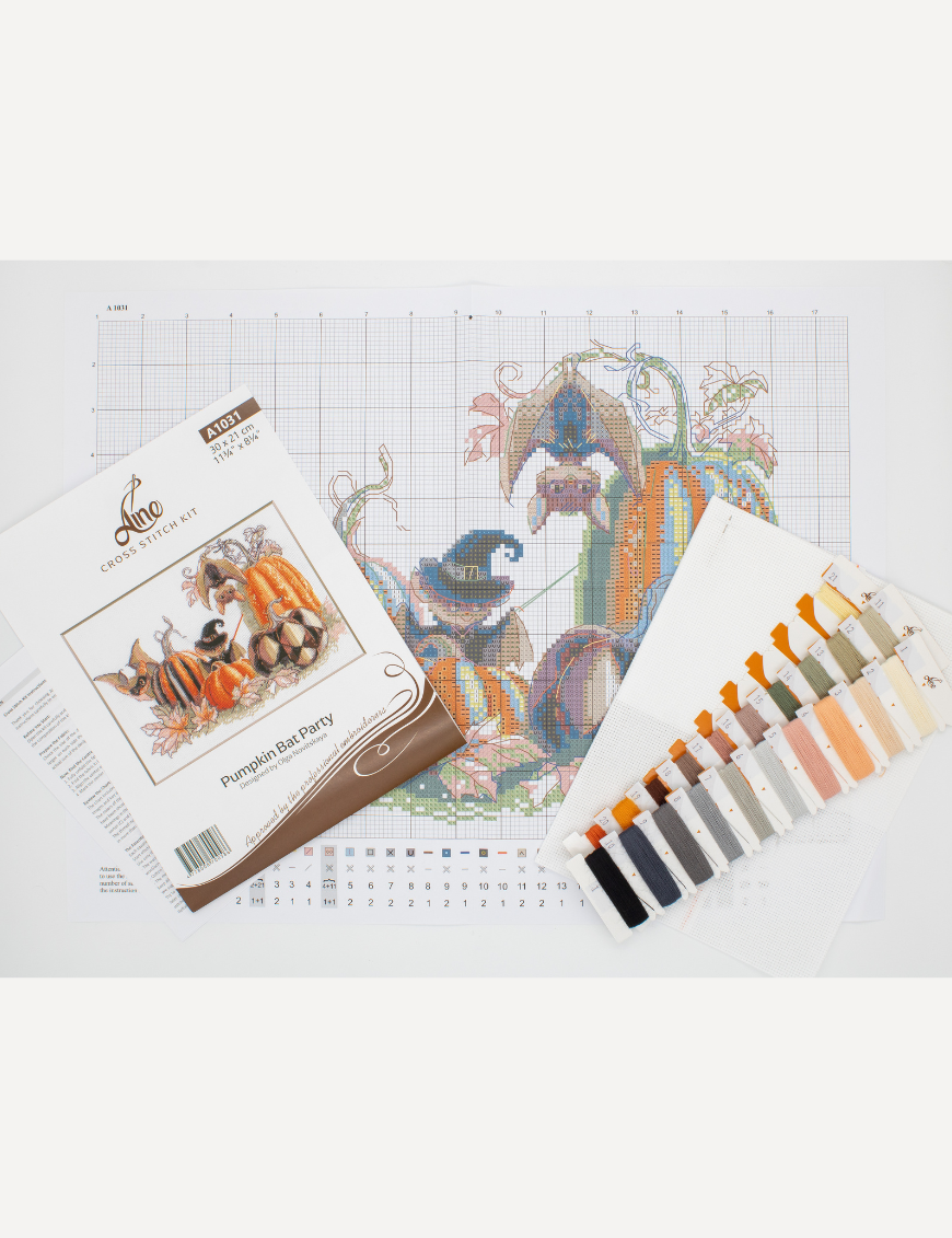 A completed cross-stitch of bats and pumpkins in a Halloween theme, with striped and checkered pumpkins, autumn leaves, and a bat in a witch hat holding a wand.
