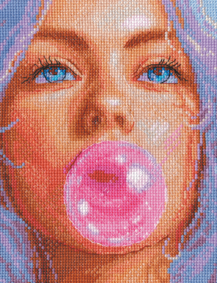 A completed cross-stitch of a girl with pastel purple hair blowing a pink bubblegum bubble, with bright blue eyes and soft blended tones.