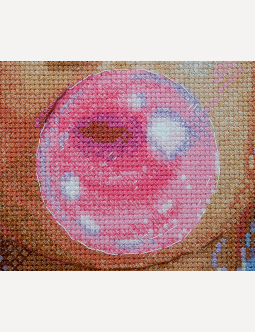 A completed cross-stitch of a girl with pastel purple hair blowing a pink bubblegum bubble, with bright blue eyes and soft blended tones.