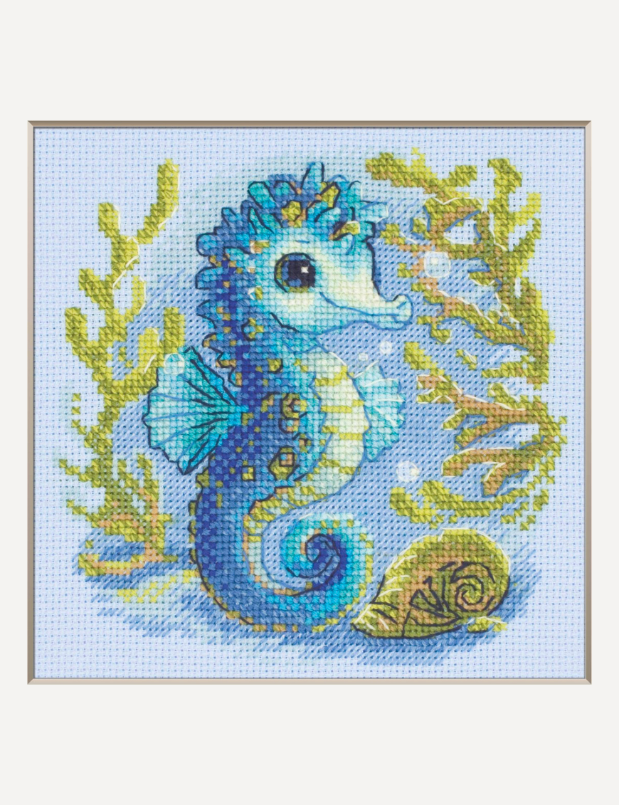 Baby Sea Horse cross stitch kit showing a blue baby seahorse underwater with golden seaweed and a shell.