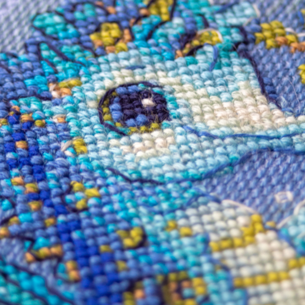Baby Sea Horse cross stitch kit showing a blue baby seahorse underwater with golden seaweed and a shell.