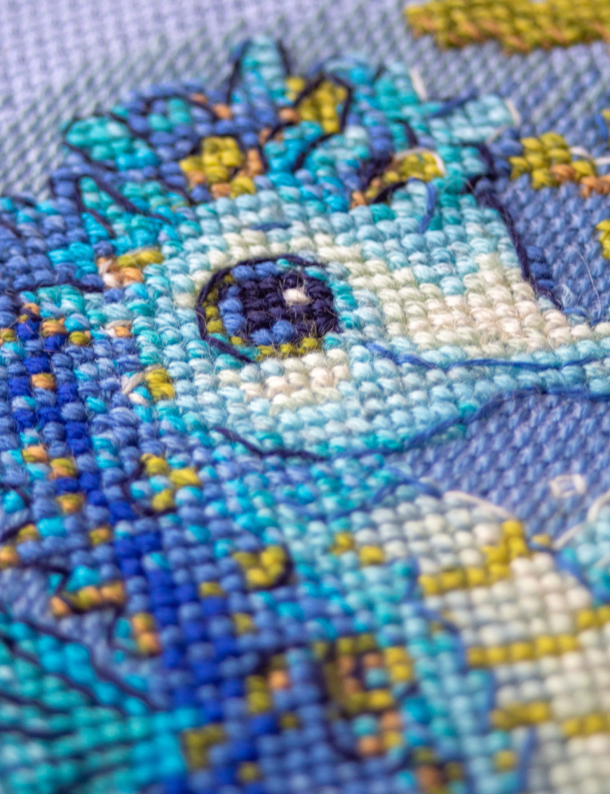 Baby Sea Horse cross stitch kit showing a blue baby seahorse underwater with golden seaweed and a shell.