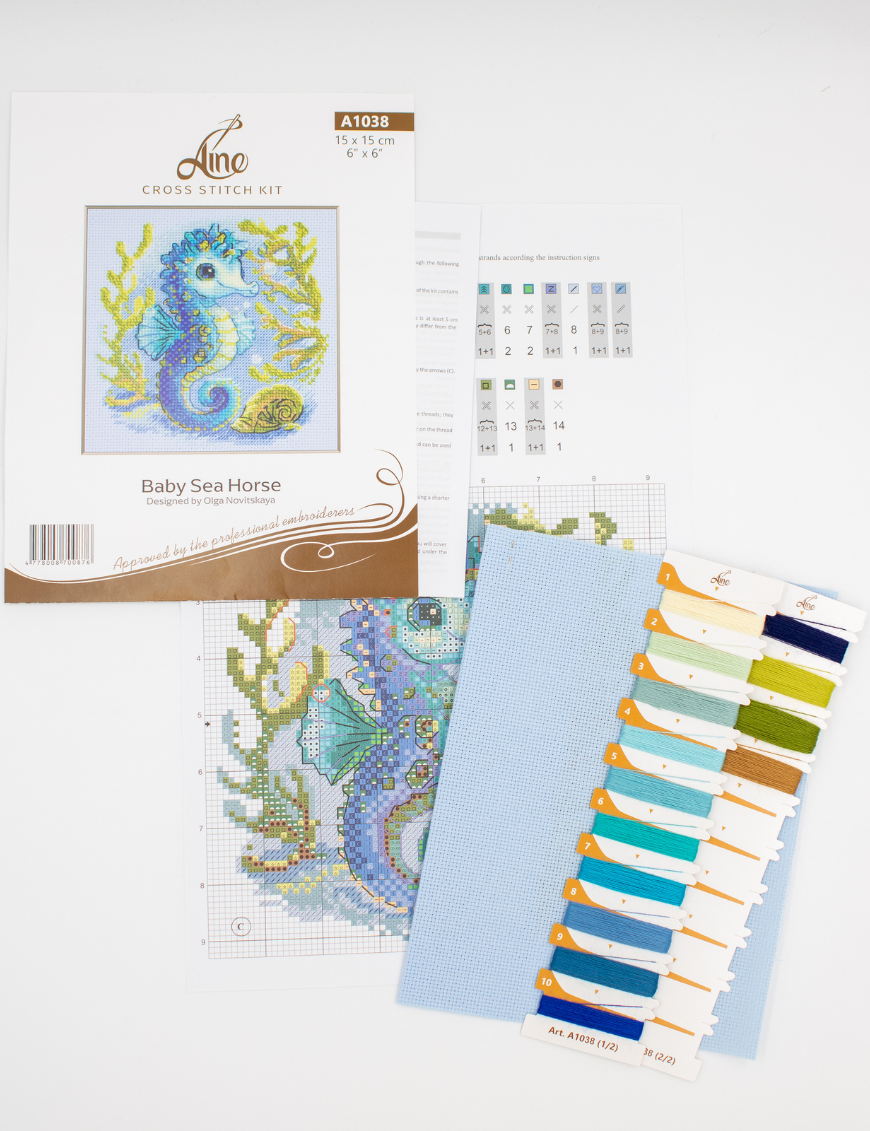 Baby Sea Horse cross stitch kit showing a blue baby seahorse underwater with golden seaweed and a shell.