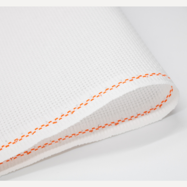 Close-up of Zweigart white Aida fabric showing the evenweave grid texture.