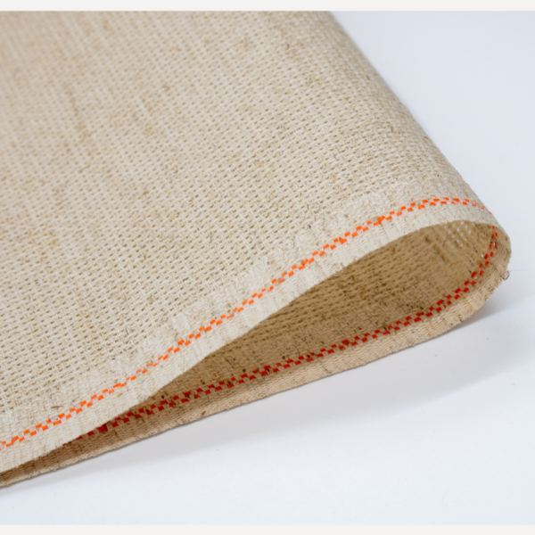 Close-up of Zweigart 10 count Rustico Aida fabric showcasing its easy-to-stitch evenweave grid and natural, earthy flecked appearance.