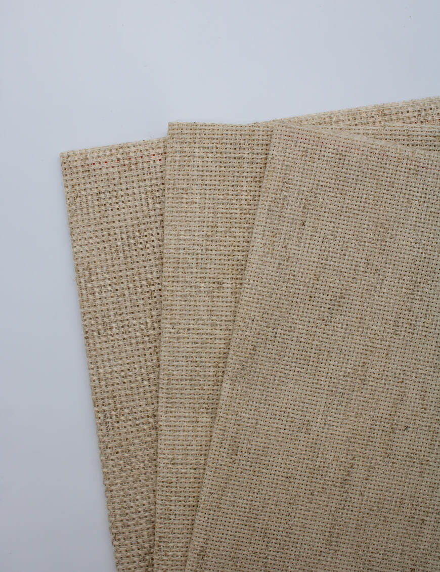 Close-up of Zweigart 10 count Rustico Aida fabric showcasing its easy-to-stitch evenweave grid and natural, earthy flecked appearance.
