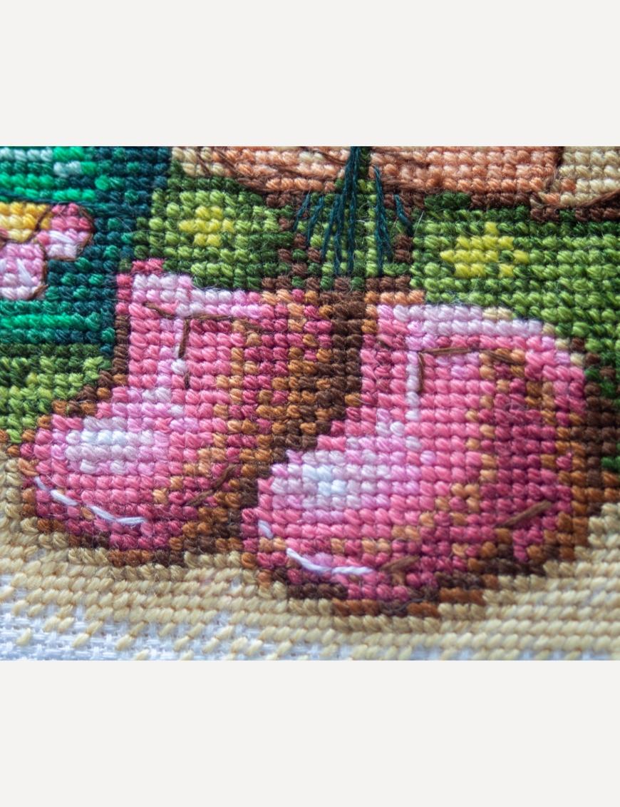 A1042 Blossom Gnome Aine Cross-Stitch Kit featuring a garden gnome in a green hat surrounded by pink flowers, foliage, and butterflies.