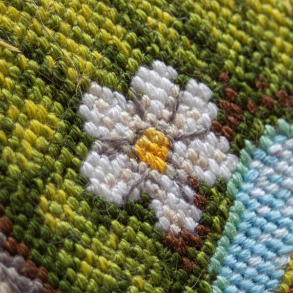A1042 Blossom Gnome Aine Cross-Stitch Kit featuring a garden gnome in a green hat surrounded by pink flowers, foliage, and butterflies.