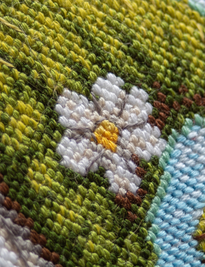 A1042 Blossom Gnome Aine Cross-Stitch Kit featuring a garden gnome in a green hat surrounded by pink flowers, foliage, and butterflies.