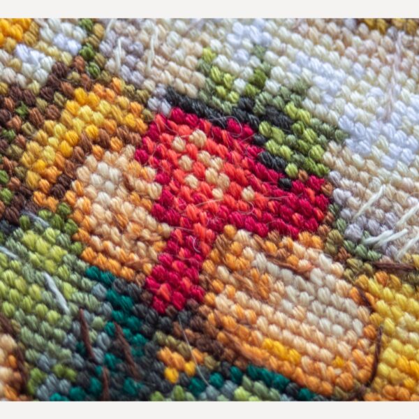 A1043 Sunshine Gnome Aine Cross-Stitch Kit featuring a garden gnome in a yellow sunflower hat surrounded by red flowers, daisies, and green foliage.