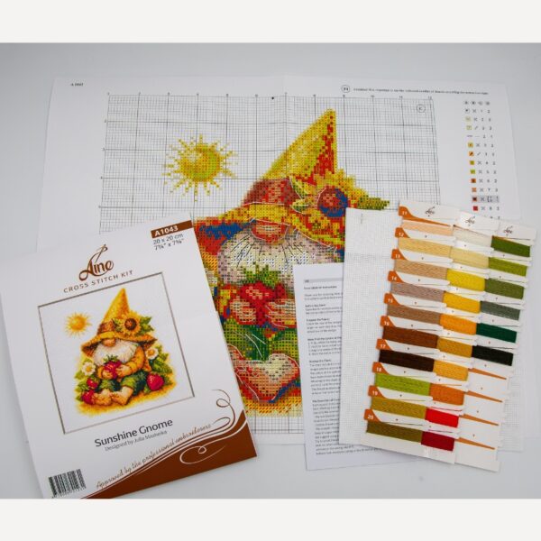 A1043 Sunshine Gnome Aine Cross-Stitch Kit featuring a garden gnome in a yellow sunflower hat surrounded by red flowers, daisies, and green foliage.