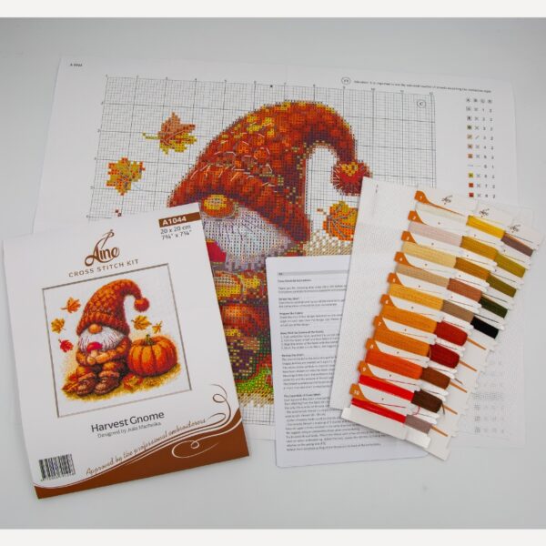 A1044 Harvest Gnome Aine Cross-Stitch Kit featuring an autumn gnome with a large orange pumpkin, colorful fall leaves, and a tiny red mushroom.