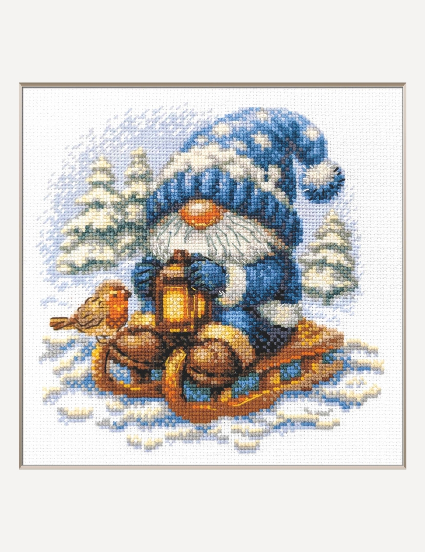 A1045 Snowy Gnome Aine Cross-Stitch Kit featuring a winter gnome with a blue snowy hat, glowing lantern, wooden sled, bird, and snow-covered evergreen trees.