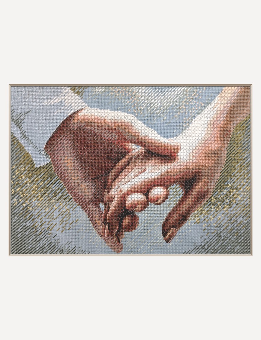 A completed cross-stitch picture of two hands gently clasped together, one in a white shirt cuff, against a soft blue-grey background with golden sparkles.