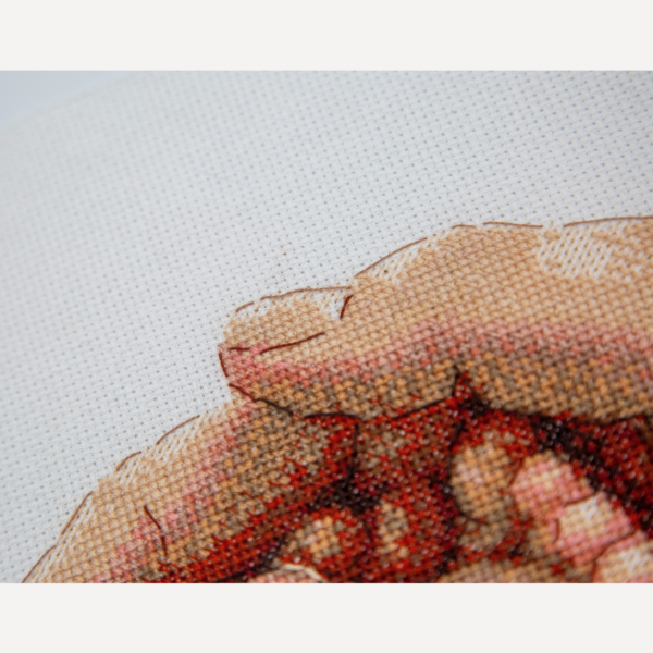 Close-up of the top edge of a cross-stitched parent’s hand curving over baby toes, with brown outline backstitch on white Aida.