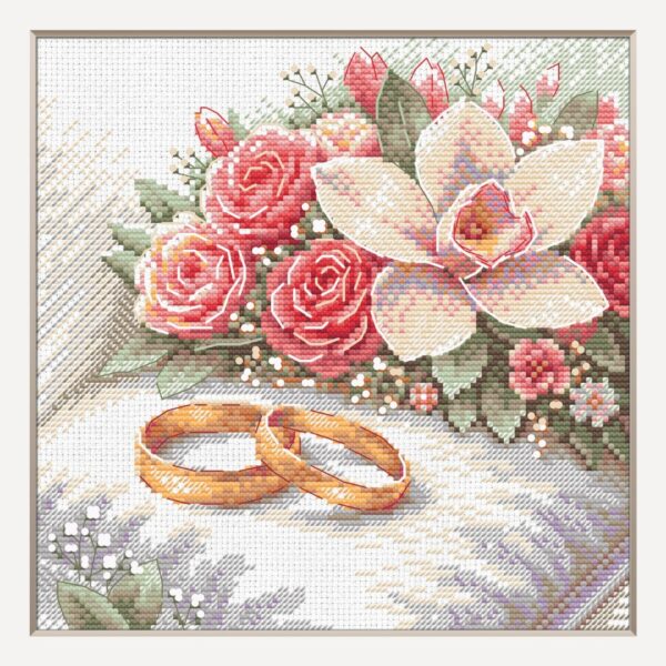 A completed cross-stitch picture of two gold wedding rings resting on soft white fabric beside a bouquet of coral-pink roses, a cream orchid and sprigs of baby’s breath with sage-green leaves.